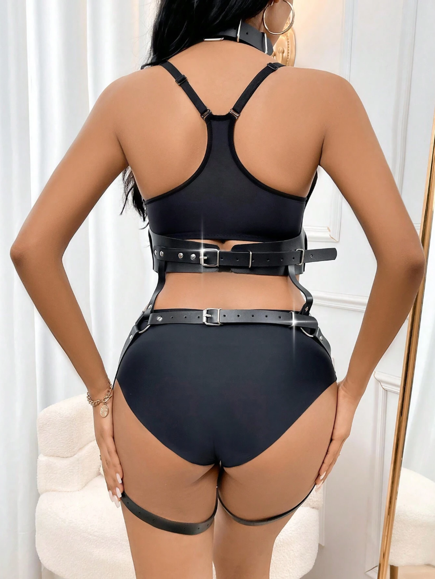 Person wearing a black lingerie set with a belt in a minimalistic setting